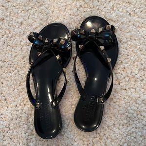 Valentino Garavani black rubber with gold rockstud thongs sandals.